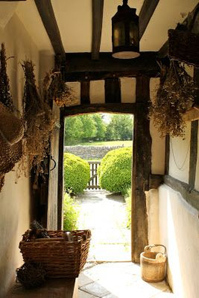 AI caption: a doorway with baskets hanging from it, country cottage