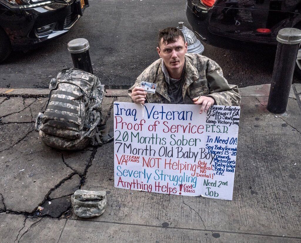 AI caption: a soldier holding a sign on the sidewalk, black and white