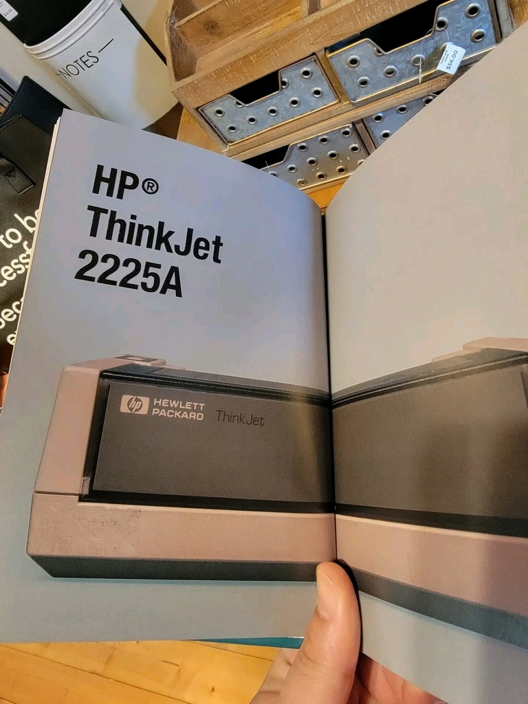 AI caption: a book with the title shitty printers, a book hp thinkjet 2250 manual