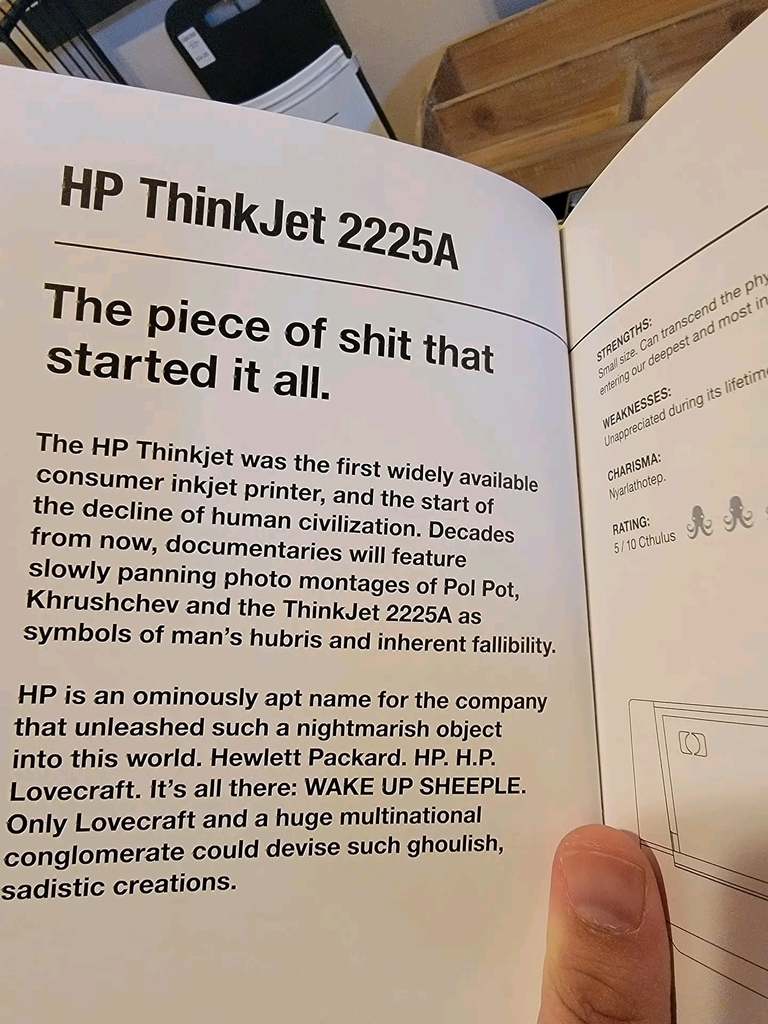 AI caption: a book with the title shitty printers, a book hp thinkjet 2250 manual, the person is holding a book, vintage hp thinkpad t220 manual, the person is holding up a book with a shit on it