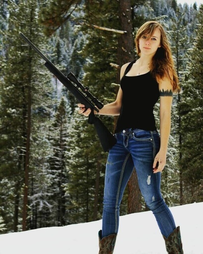 AI caption: a girl holding a rifle in the snow, portrait