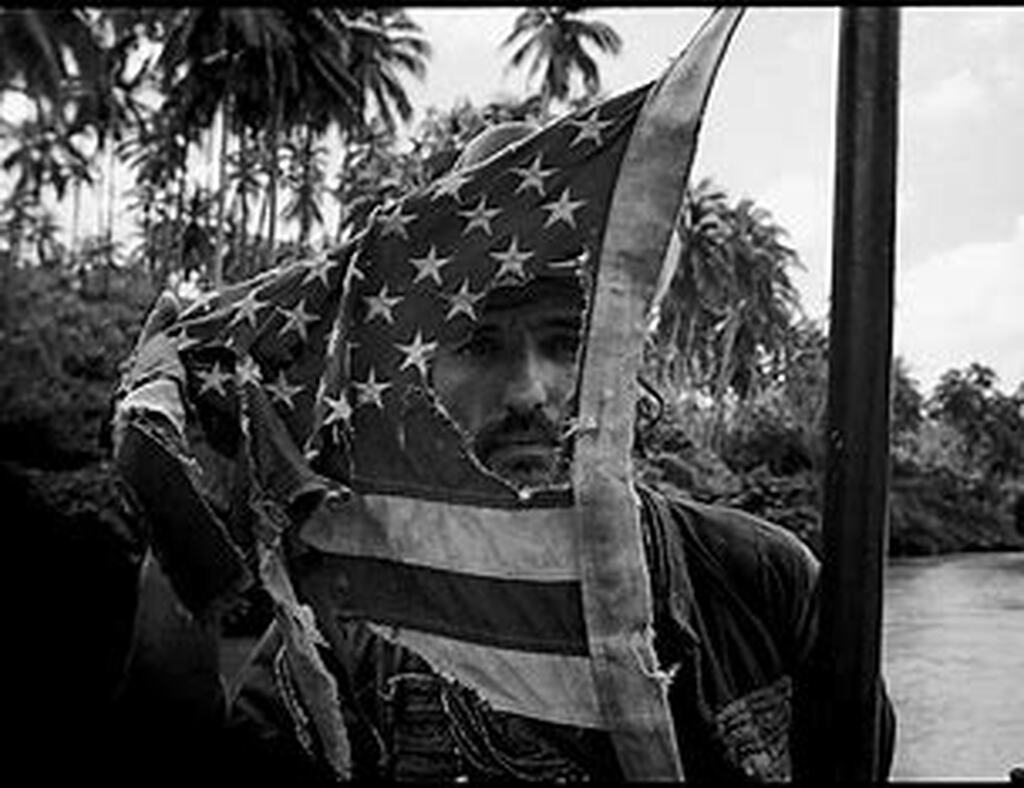 AI caption: a man holding an american flag in the river, black and white