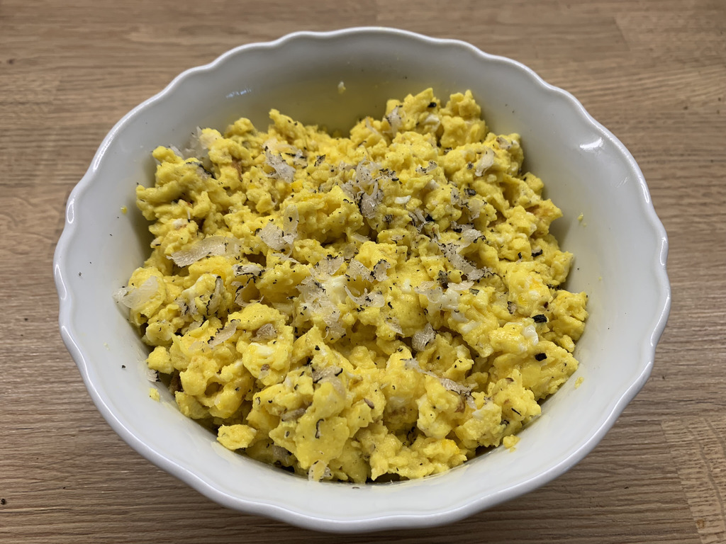 AI caption: scrambled eggs with chives and parsley, flat