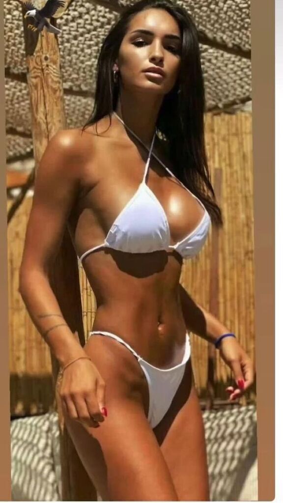 AI caption: a woman in a white bikini posing, a bikini