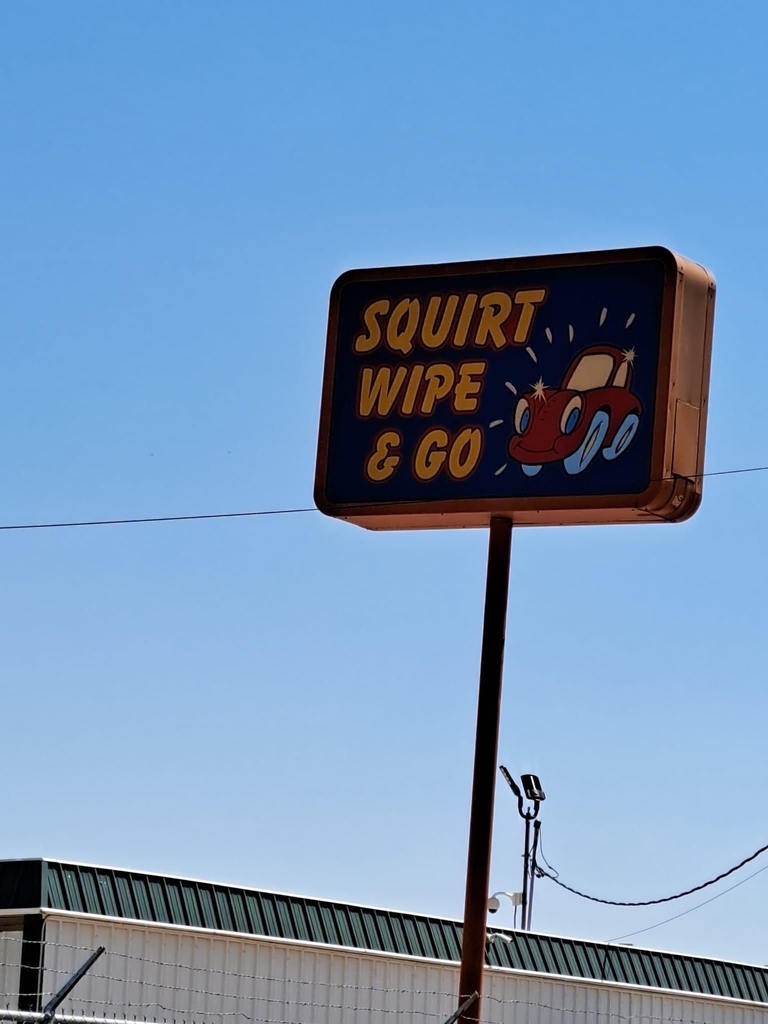 AI caption: squirt wipe & go sign, black and white