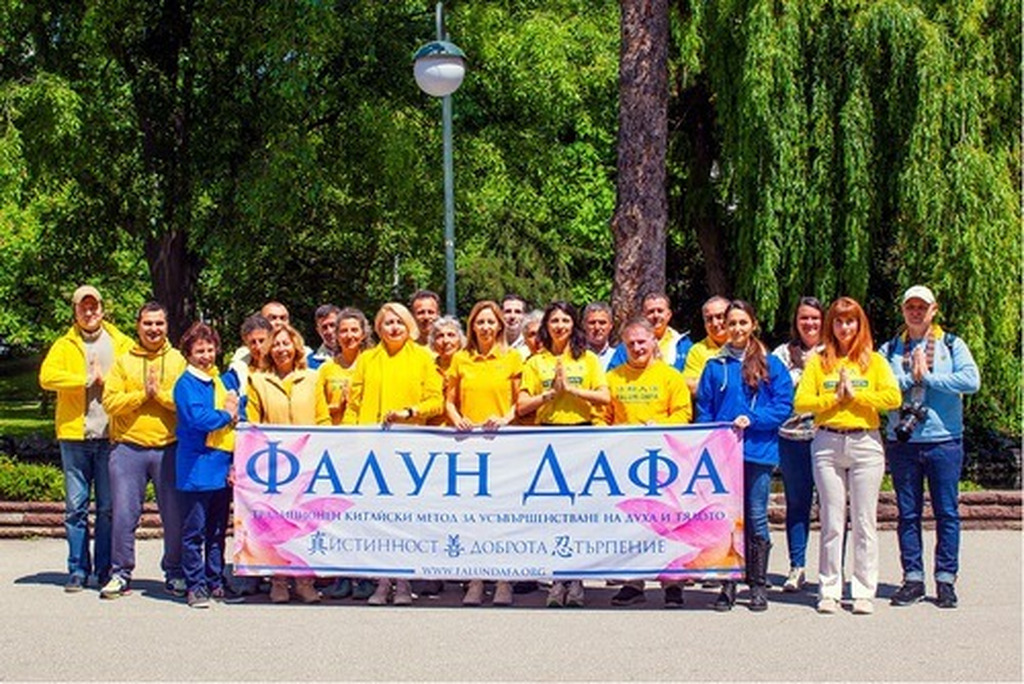 AI caption: a group of people in yellow shirts holding a banner, group portrait
