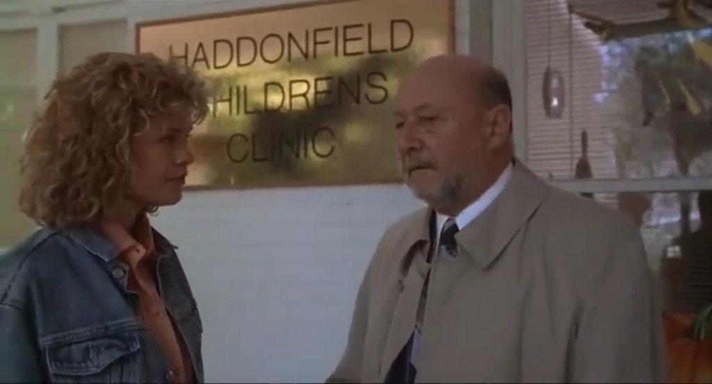 AI caption: a man and woman talking in front of a sign, portrait